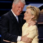 Former President Clinton embraces wife Hillary before speaking at Democratic National Convention